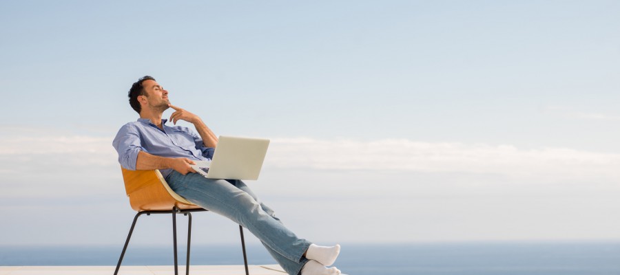 relaxed young man at home on balcony